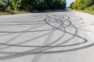 skid marks on a road surface. Circular tire marks left by drivers doing doughnuts