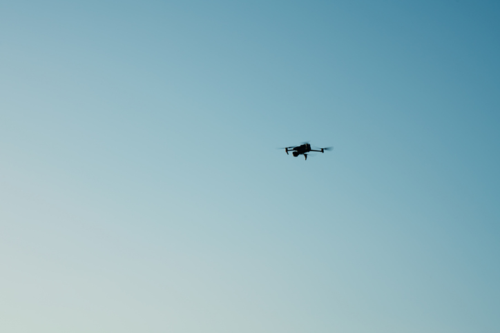 A flying drone against sky
