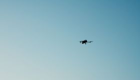 A flying drone against sky