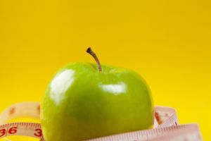 measuring tape and apples