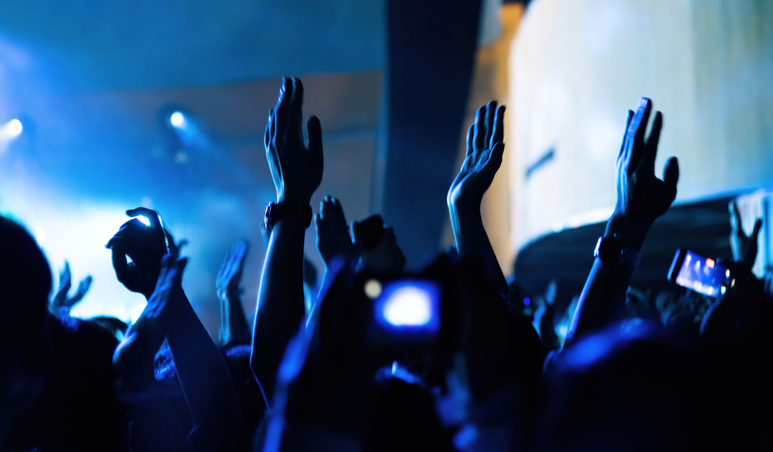 People clapping hands at music festival