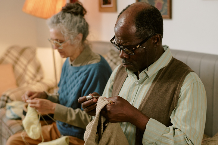 Senior Caucasian Woman and Senior Black Man Creating Handmade Garments Together