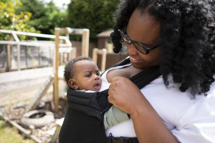 Mother carrying baby son (2-5 months)