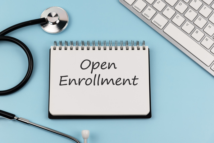 Stethoscope and notepad with text open enrollment