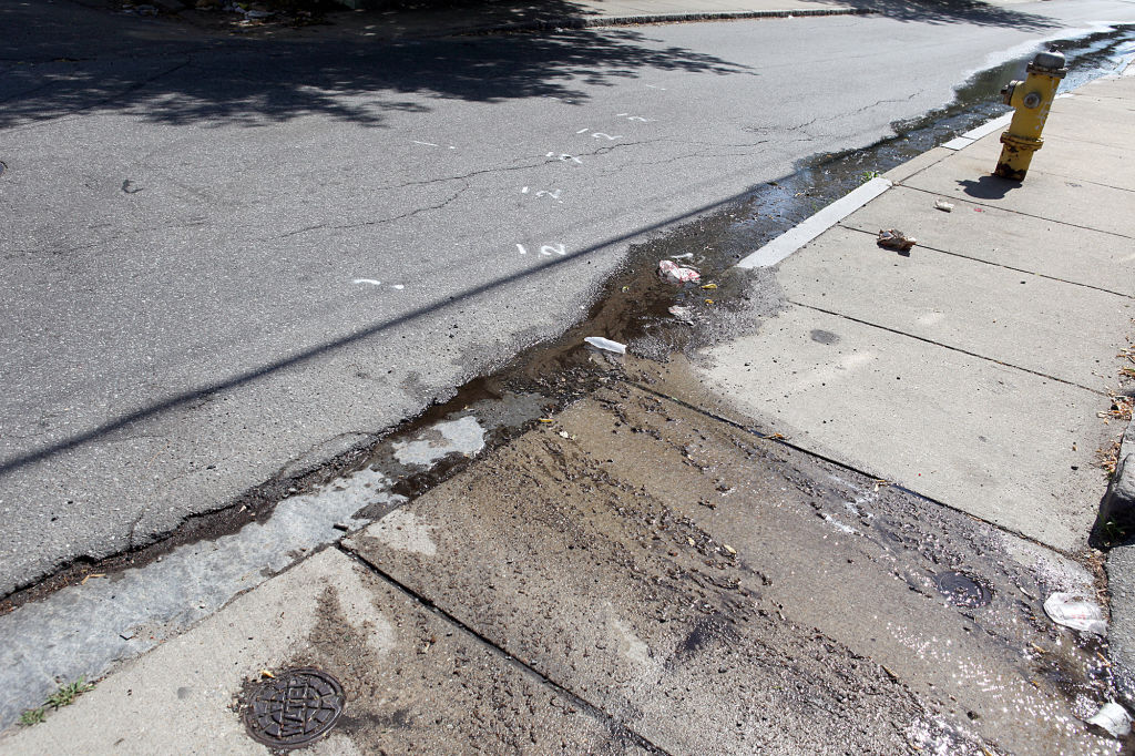 (052610 Lawrence, MA) Jordan Pe˚a was hit by a car in front of this driveway on Fern Street and was tossed by the crash into the fire hydrant, Wednesday, May 26, 2010. Staff photo by Angela Rowlings.