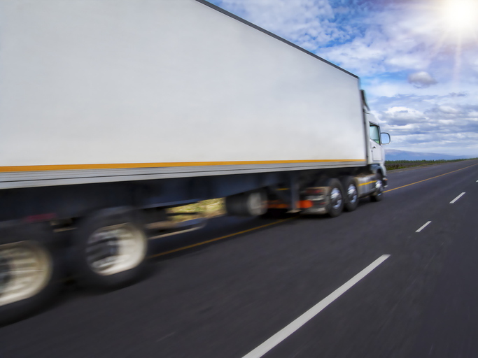 motion blur of truck speeding on the highway at sunset, transport, haulage and logistics concept