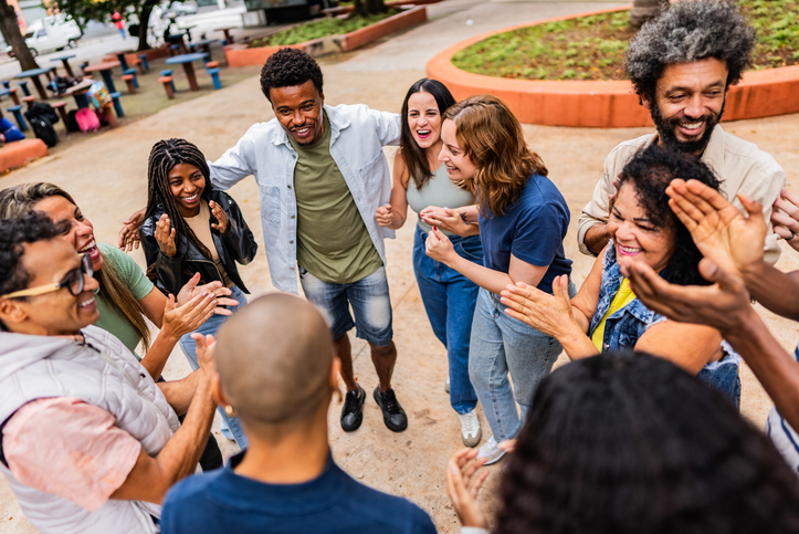 Friends applauding outdoors
