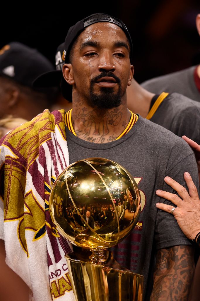 Cleveland Cavaliers' J.R. Smith (5) sheds tears as he holds the Larry O'Brien trophy after defeating the Golden State Warriors in Game 7 of the NBA Finals at Oracle Arena in Oakland, Calif., on Sunday, June 19, 2016. The Cleveland Cavaliers defeated the G