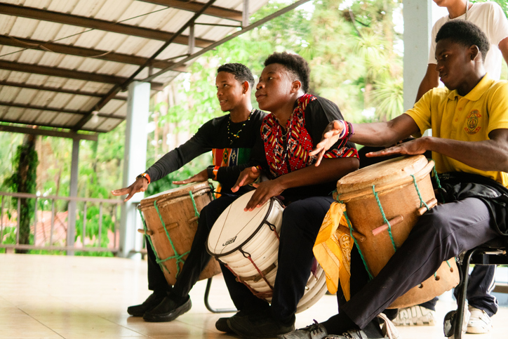 Young garifuna students learning to play traditional drums