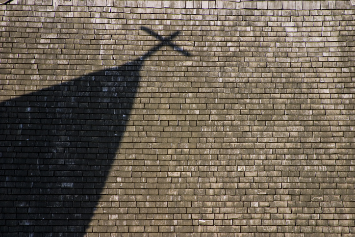 Shadow of steeple with cross on Church roof