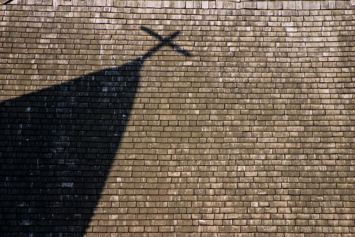 Shadow of steeple with cross on Church roof